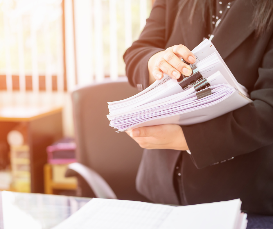 woman with stack of documents